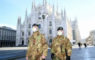 Italian Military officers wearing face masks outside Duomo cathedral, closed due to the coronavirus outbreak.